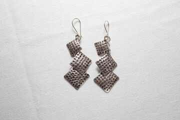 Antique real silver earring on white cloth background