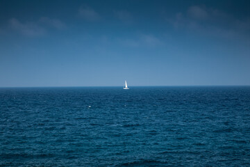 Lone sailing boat in the Adriatic Sea between Italy and Greece