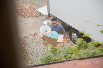 Family moving, unloading moving van