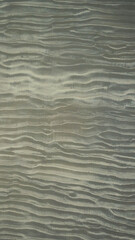 Aerial texture view of the sand on the beach at low tide.