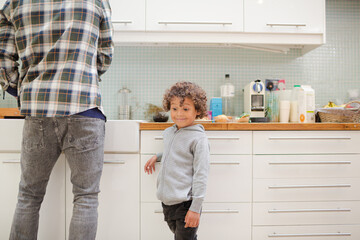 Father and son standing in kitchen