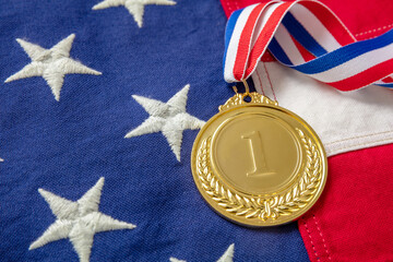 Medal gold for USA. Winner prize award with ribbon on US flag background.