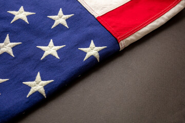 USA sign symbol. United States of America flag folded on black color background, copy space