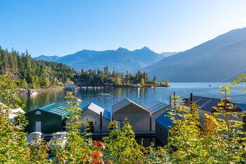 Morning sun on the shipyards, marina and dock on Kootenay Lake in Kaslo Bay, in the rural small village of Kaslo, British Columbia, Canada. - Powered by Adobe