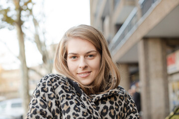 Portrait confident young woman in leopard print coat