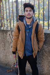 Portrait confident young man with skateboard