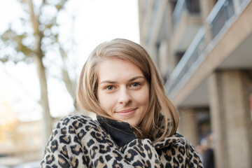 Portrait confident young woman in leopard print coat