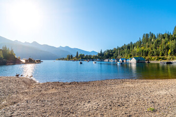 Morning sun on the shipyards, marina, beach and dock on Kootenay Lake in Kaslo Bay, in the rural small village of Kaslo, British Columbia, Canada.