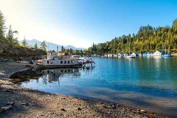 Fishing boats, paddle wheel boats and boathouses at Kaslo Bay on Kootenay Lake in the rural Canadian town of Kaslo, BC.