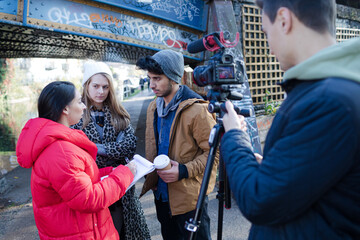 Fototapeta premium Portrait happy young adult friends vlogging outdoors