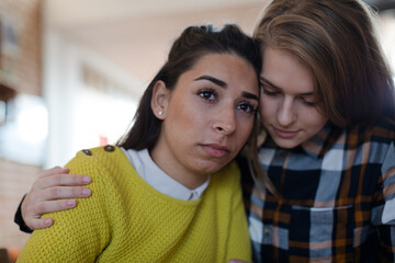 Teenage girl comforting upset friend