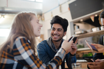 Young adults using smart phones at table