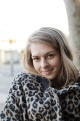 Portrait confident young woman in leopard print coat