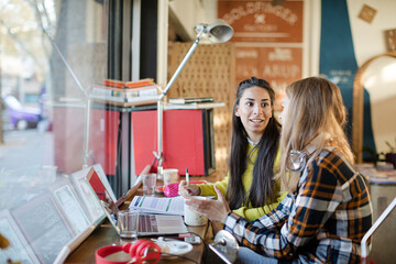 Young female college students studying in cafe