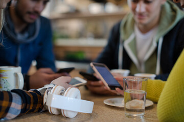 Young adult friends using smart phones