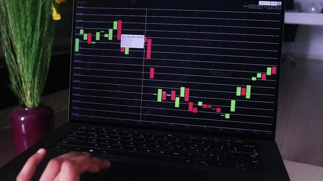 African Woman Checking Bitcoin Stock Chart In Her Living Room