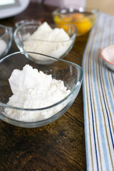 White gluten free pizza flour in wooden scoops