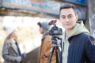 Young adults vlogging under urban bridge