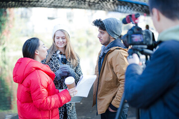 Young adults vlogging under urban bridge