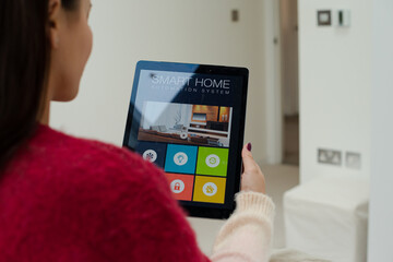 Woman using smart home automation system with digital tablet