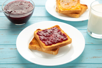 Sweet toasts with jam for breakfast on blue table