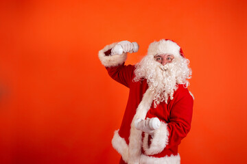 Cute toast santa claus with dumbbells in his hands on an orange background. Sports nutrition and exercise for weight loss.
