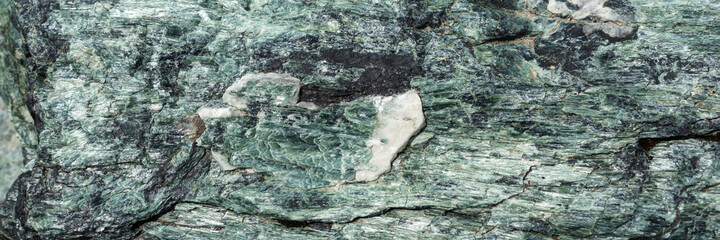 Natural green granite stone as background. Panorama
