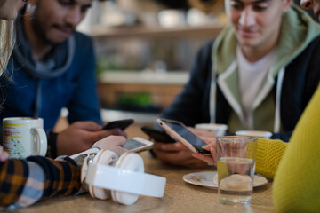 Young adult friends using smart phones