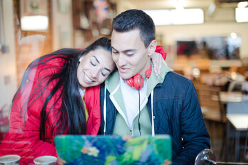 Young couple using laptop in cafe