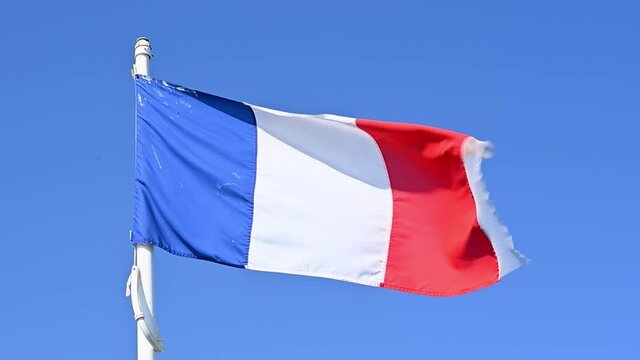 Flag of France known as the Tricolour proudly fluttering in the breeze. Slow motion.