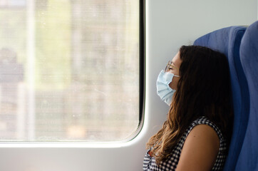 young woman wearing glasses rests on her train ride. businesswoman enjoys her vacations traveling by train. time for relax. time to relax while traveling