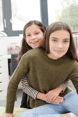 Portrait smiling sisters in room