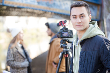 Young adults vlogging under urban bridge