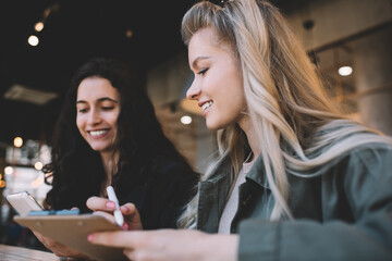 Satisfied coworkers watching video on smartphone