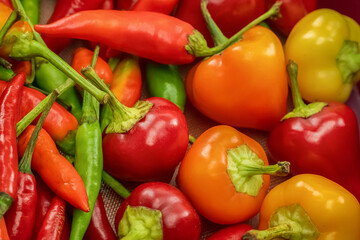 hot red and orange peppers close-up, fresh vegetables background