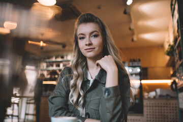 Woman in casual wear sitting in coffee shop