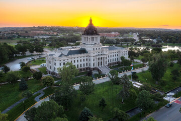 South Dakota State Capitol building in Pierre, SD. Aerial drone view at sunrise with golden glow...