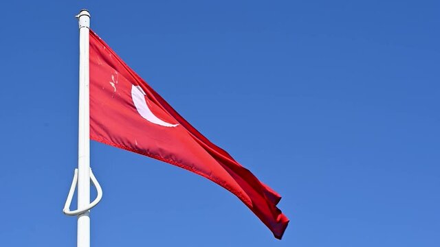 Flag of the Turkey a red flag with a star and crescent also known as al bayrak, proudly fluttering in the breeze. Slow motion.