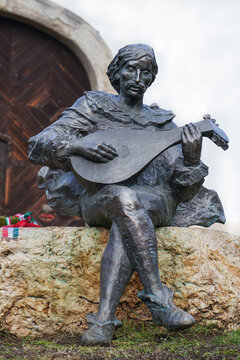 Hungary, Eger 10.12.2019. Statue of a musician playing a lute, sitting on a stone