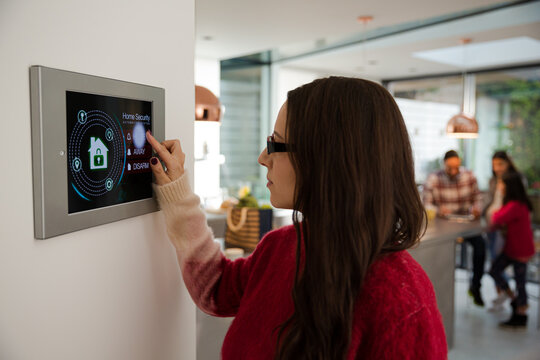 Woman using smart home automation system with digital tablet