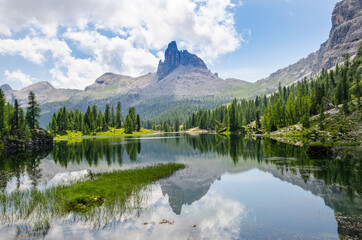 Dolomites. Lake Federa, 2038 meters above sea level. The mountains and trees are reflected in the still and crystal clear water of the lake