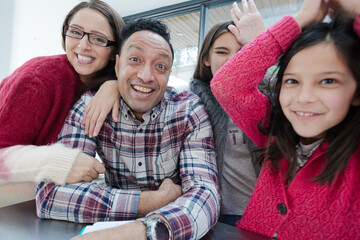 Playful family taking selfie with digital tablet in morning kitchen