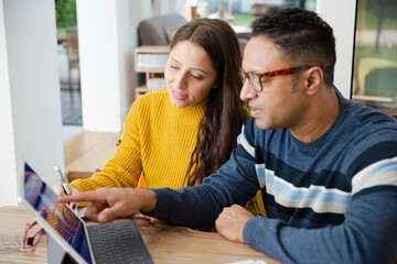 Couple paying bills online, using fingerprint log on at digital tablet