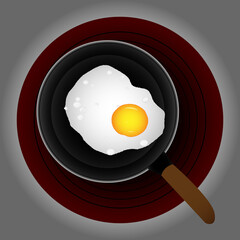 Fried egg in a black frying pan on an electric stove.