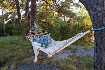Hammock between two trees, ready to use, with pillow, blanket and a good book. Perfect for...