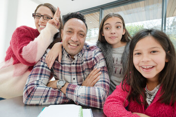 Playful family taking selfie with digital tablet in morning kitchen