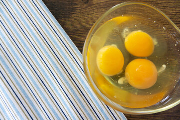 Fresh Egg With Bowl of Egg White on Wooden Table, Food Rustic Style.