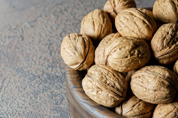 Walnuts on a dark brown background. Close up. Side view.