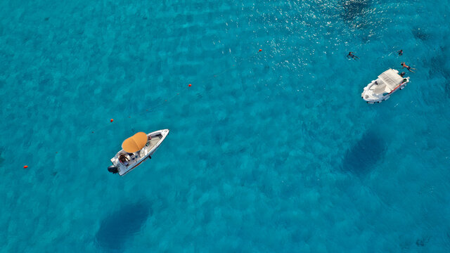 Aerial photo of small boats anchored in tropical Caribbean island bay with turuqoise clear sea