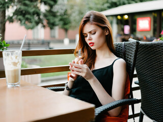 woman resting in a summer cafe outdoors socializing breakfast